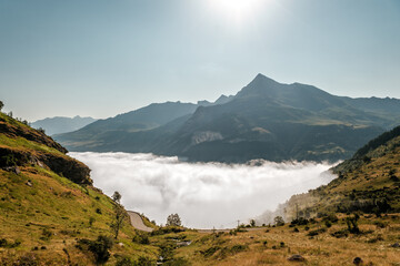 Mist hanging in the Gavarnie valley below the peak of Piméné viewed from D923 road up to the Col de Tente in the French Pyrenees