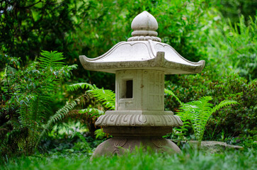 Stone lantern in japanese garden, closeup of photo.