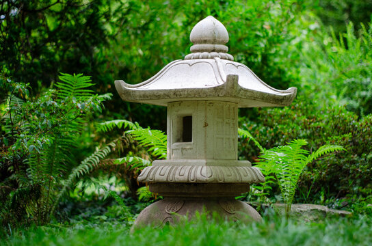 Stone lantern in japanese garden, closeup of photo.