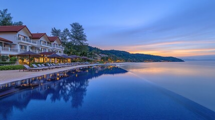 Fototapeta premium Tranquil infinity pool at a beachfront resort at dawn.