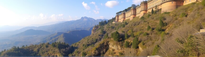 Naklejka premium Mountains and a body of water with a building on top of it