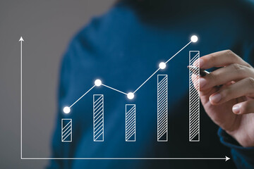 A person analyzing a growth chart with upward trends, signifying progress and success in data or...