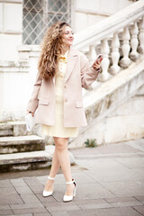 A beautiful woman with culrs hair weared business style suit, the girl is  holding a notebook and...