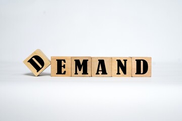 the word DEMAND on a wooden cube. the concept of writing on a wooden cube.