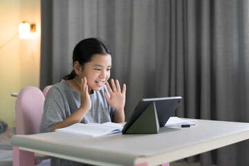 study online class by asian child smile learning on computer tablet or kid girl student fun studying or young woman people happy learn from home school by video call technology education in classroom
