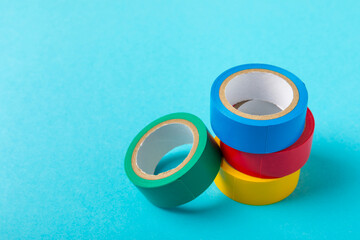 Insulating tape on a bright colored background. Set of different colors insulating tape. Reel...