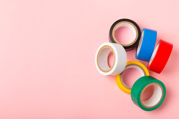 Insulating tape on a bright colored background. Set of different colors insulating tape. Reel...