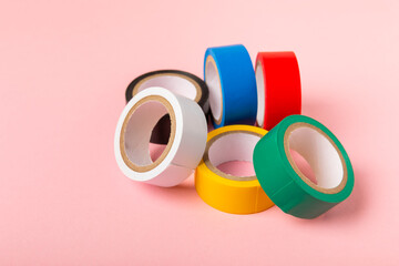Insulating tape on a bright colored background. Set of different colors insulating tape. Reel...