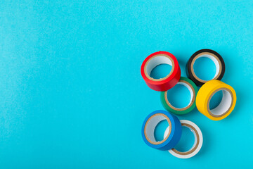 Insulating tape on a bright colored background. Set of different colors insulating tape. Reel...