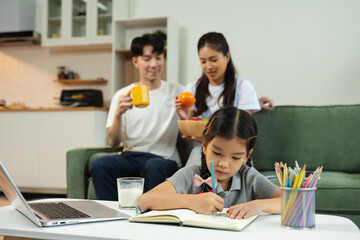 Family Asian spending happy time together on vacation, daughter homework on holiday.