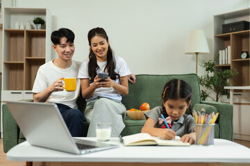 Family Asian spending happy time together on vacation, daughter homework on holiday.