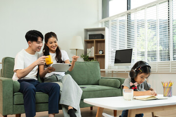 Family Asian spending happy time together on vacation, daughter homework on holiday.