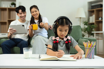 Family Asian spending happy time together on vacation, daughter homework on holiday.
