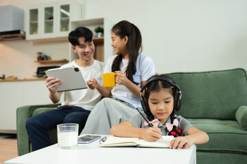 Family Asian spending happy time together on vacation, daughter homework on holiday.