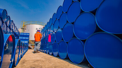 Male worker inspection record drum oil stock barrels blue horizontal