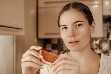 Woman Grapefruit Kitchen Healthy Eating: Portrait, indoor, present, nutritious breakfast.