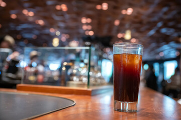 Ice Americano in grass by coffee machine on table, Shanghai, China