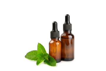 Essential oil mint isolated on white background. Peppermint essential oil with fresh mint leaves. A bottle of aromatherapy oil. Mint extract. The concept of natural cosmetics, spa care