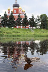 A Beautiful Scenic Reflection of a Historic Church Adjacent to a Serene Waterbody