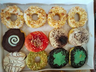 12 donuts in a box, with various flavors