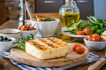 A gourmet grilled cheese wheel, garnished with herbs, ready for a delightful meal
