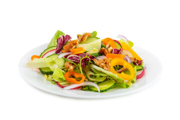 Cucumber salad isolated on white background. Homemade salad with fresh vegetables, cucumber, tomato, sweet pepper and lettuce in a plate. Vegetarian spring salad. Vegetarian diet. Healthy eating.