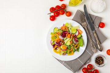 Cucumber salad on a wooden background.Homemade salad with fresh vegetables, cucumber, tomato, sweet...