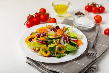 Cucumber salad on a wooden background.Homemade salad with fresh vegetables, cucumber, tomato, sweet...