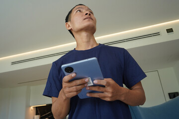 Worker with tablet computer checking alarm system