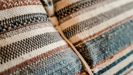 A macro closeup of a cozy, hand-woven textile with rustic stripes and a rich, tactile texture - Powered by Adobe