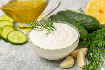Cucumber sour cream tzatziki sauce on a wooden table.Tartar sauce. Traditional delicious appetizer....