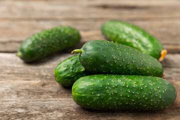 Cucumber on wooden background. Slice of cucumber on background. Fresh organic green cucumbers...