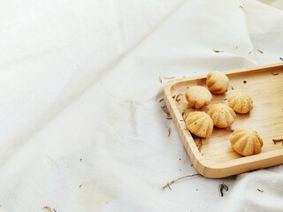 Petite Madeleine Kue Bhoi Cookies on Wood Tray, Soft Lighting