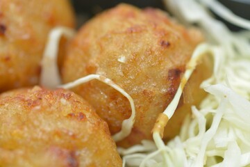 Golden-brown takoyaki ball captured in macro detail