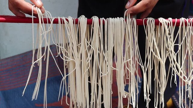 Making homemade noodles, &mdash; showcasing a traditional Indian method of preparing noodles using natural sunlight