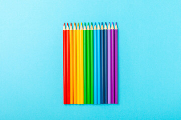 Colored pencils on a bright colored background. Equipment for coloring. Stationery for...