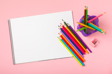 Colored pencils on a bright colored background. Equipment for coloring. Stationery for...