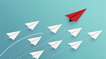 A red paper airplane leads a group of white paper airplanes, symbolizing leadership and direction