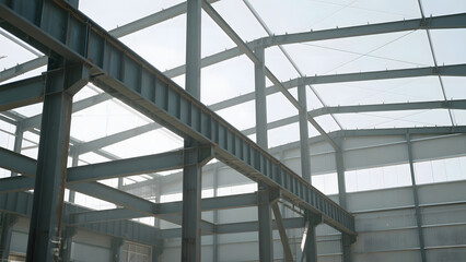 Interior of a modern industrial building with steel beams and large windows