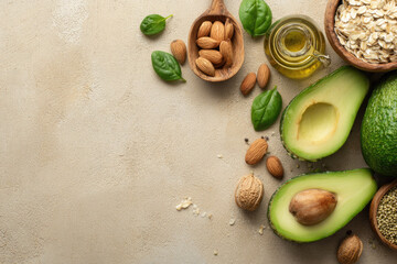 Avocado almond walnut oat olive oil basil leaf and seed arranged on beige background healthy ingredient for balanced diet top view natural and fresh concept
