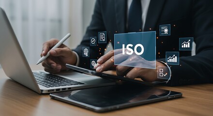 Business professional using technology for I S O certification