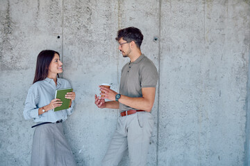 Two business partners enjoying a coffee break, engaging in lively conversation and sharing smiles...