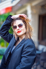 Confident woman in black blazer with lipstick
