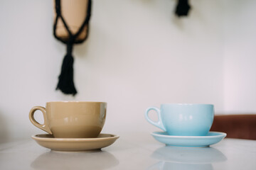 Two cappuccino cups on white table surface