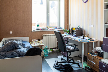 Clutter mess trash and dirt in a 15-16 year old teenage boy's room with scattered belongings,...