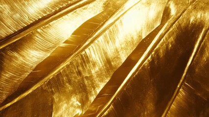 Lush bunch of shimmering gold leaf pieces glimmering under natural light for textural backgrounds