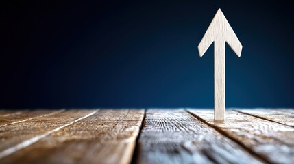 Wooden arrow pointing upward on rustic wooden surface symbolizing progress