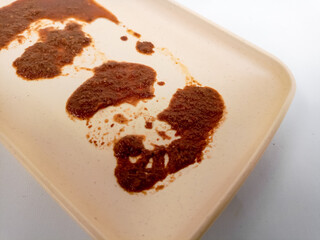 Dirty plate isolated, empty bowl after dinner, ready lunch, smeared ketchup sauce on white plate background.