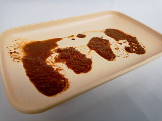 Dirty plate isolated, empty bowl after dinner, ready lunch, smeared ketchup sauce on white plate...