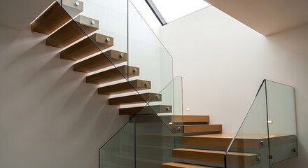 Modern staircase featuring floating wooden steps and a clear glass railing against a white wall.